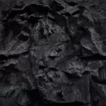 Volumetric rock texture. 3D effect. Black stone background for your design.